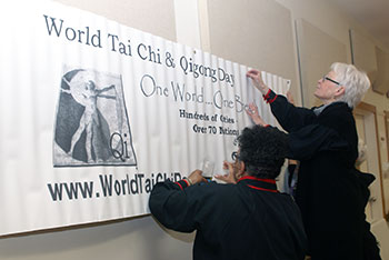 Posting a World tai Chi and Qigong Day banner at the Lewes Senior Activity Center